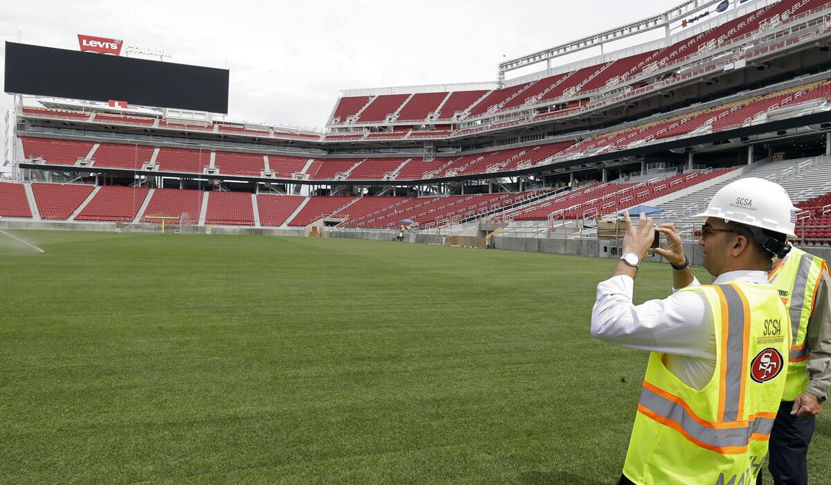 San Francisco 49ers President Paraag Marathe takes pictures of the newly installed turf at Levi's Stadium in Santa Clara during a tour last month.