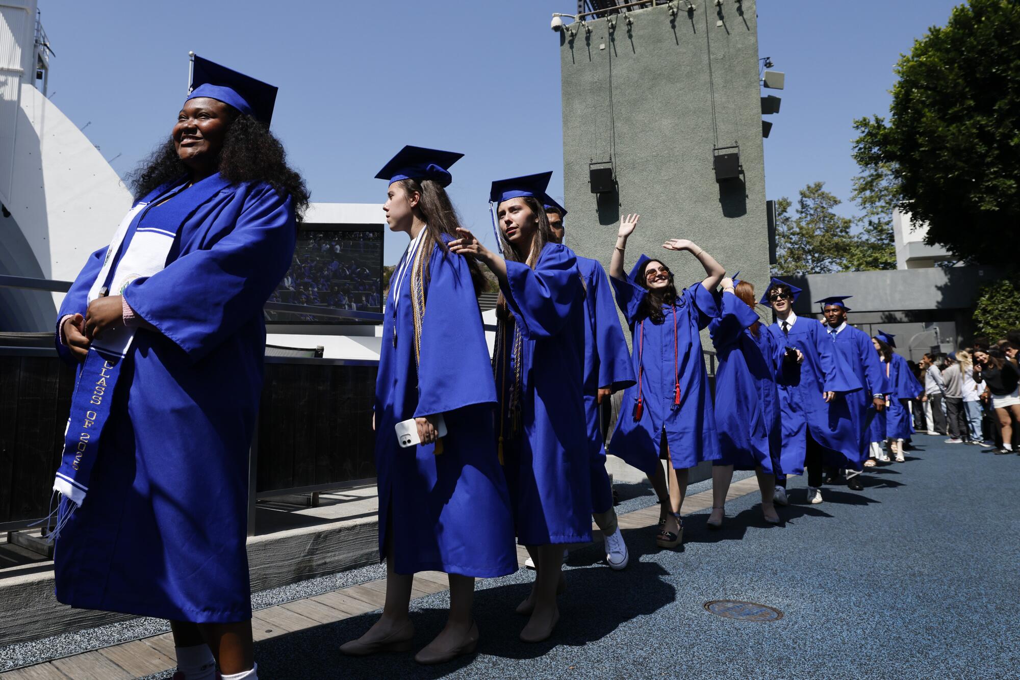 A group of young people in blue robes.