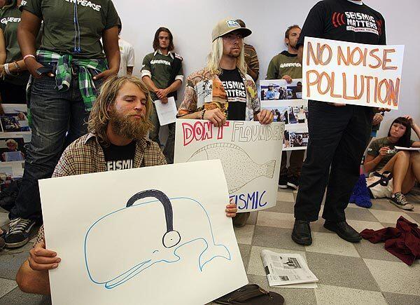 At the California Coastal Commission's meeting in Santa Monica on Wednesday, Cody Riechers shows his support for protecting whales from the sonic blasts involved in seismic testing sought by Pacific Gas and Electric Co.