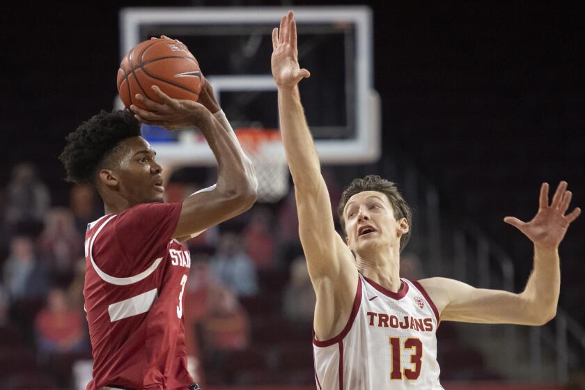 Stanford forward Ziaire Williams, left, shoots over Southern California guard Drew Peterson during the first half of an NCAA college basketball game Wednesday, March 3, 2021 in Los Angeles. (AP Photo/Kyusung Gong)
