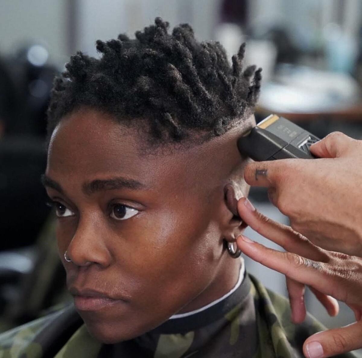 A person gets their hair cut with clippers at High & Tight.