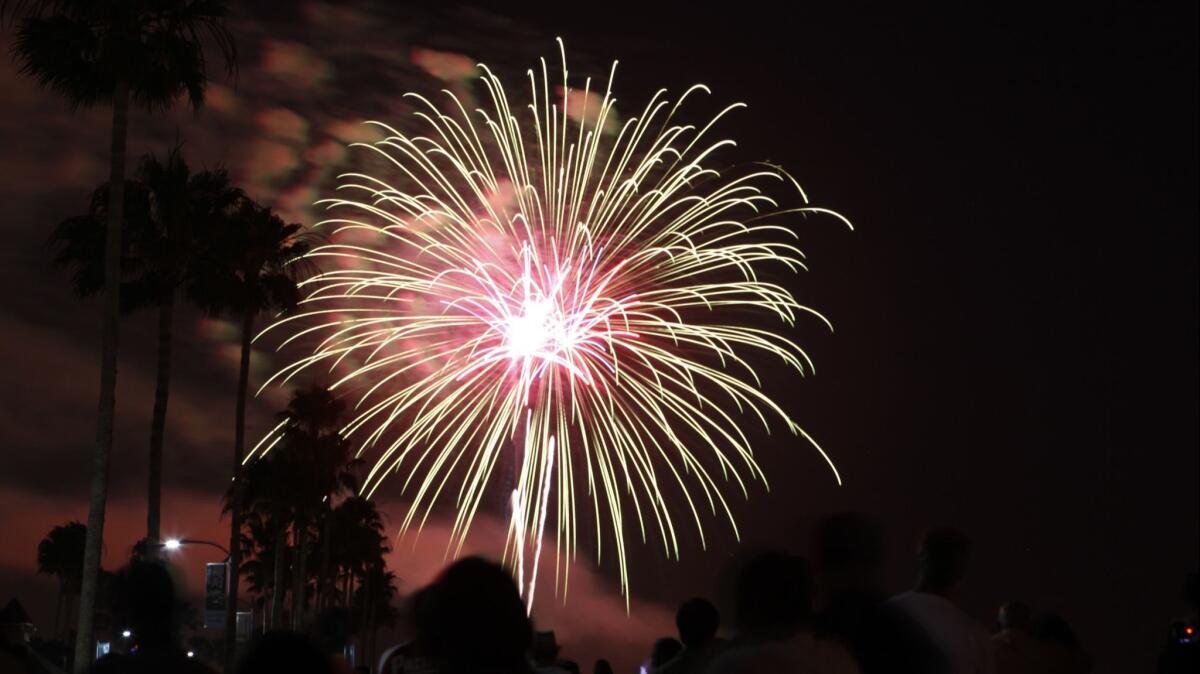 Fourth of July fireworks explode in Long Beach as seen from Shoreline Village in a file photo.