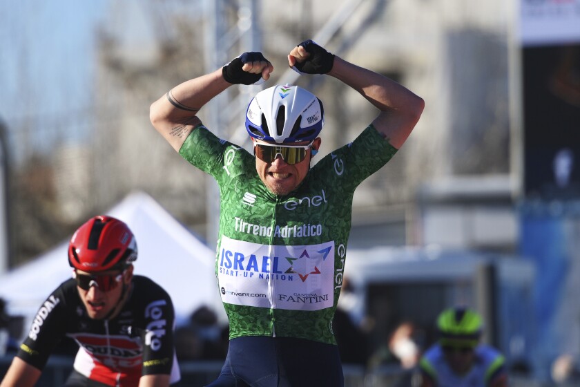 Denmark's Mads Würtz Schmidt celebrates as he crosses the finish line to win the sixth stage of the Tirreno Adriatico cycling race, from Castelraimondo to Lido di Fermo, Italy, Monday, March 15, 2021. (Marco Alpozzi/LaPresse via AP)