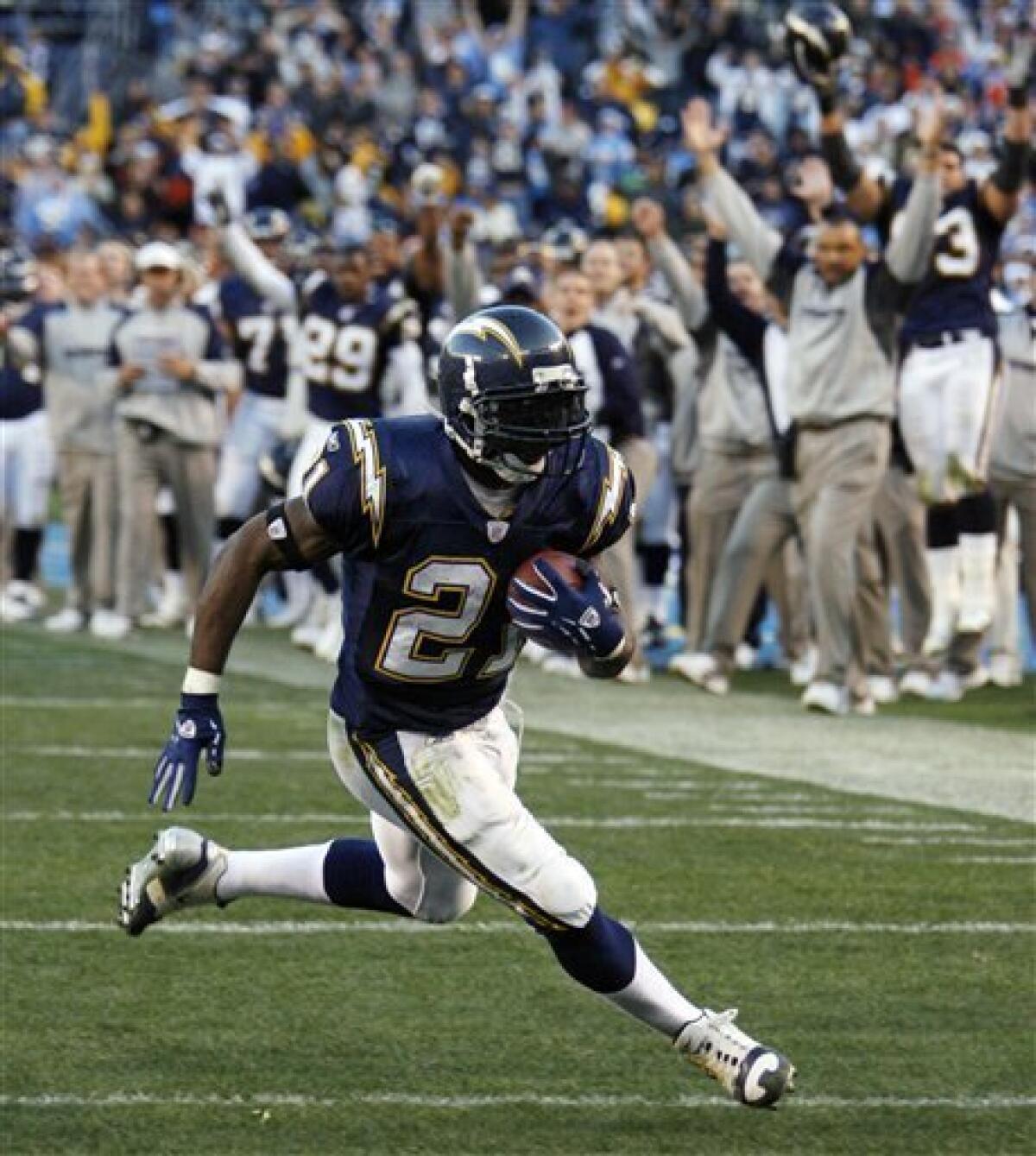 FILE - This Dec. 10, 2006 file photo shows San Diego Chargers running back LaDainian Tomlinson turning the corner on a seven-yard touchdown run during the fourth quarter of the Chargers' 48-20 victory over the Denver Broncos in a football game in San Diego. Two years after leaving under unhappy circumstances, Tomlinson returns to the Chargers to sign a one-day contract and then announce his retirement after 11 mostly brilliant NFL seasons. (AP Photo/Denis Poroy, File) — AP