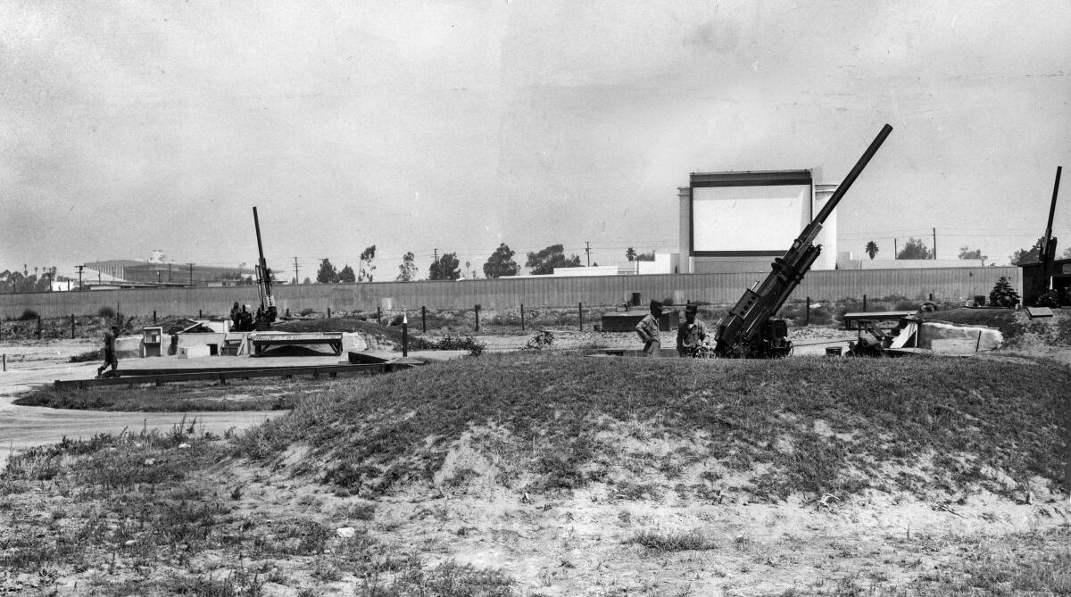 Aug. 17, 1955: Antiaircraft guns of the 77th AAA Gun Battalion in Inglewood lie in the shadow of a drive-in movie theater and Hollywood racetrack, left.