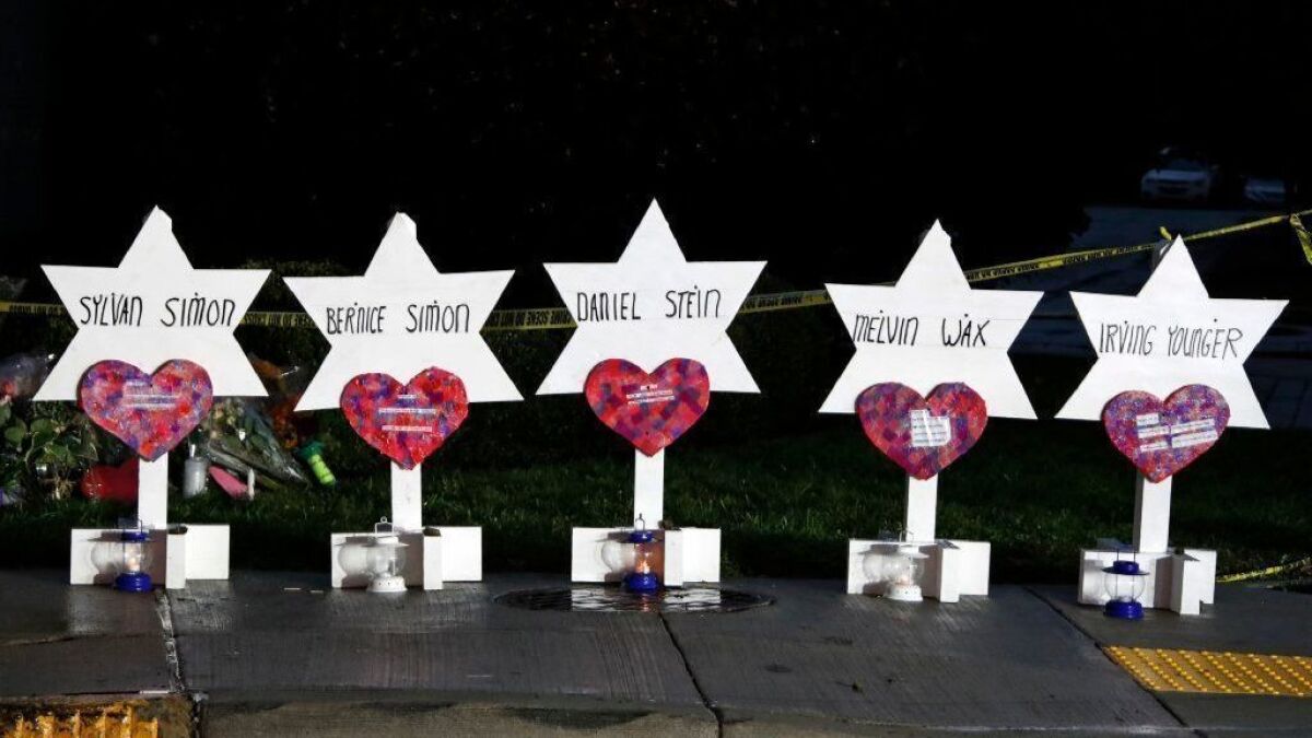 Stars of David with the names of five of the 11 people killed at the Tree of Life Synagogue on Oct 28 are part of a memorial outside the Pittsburgh temple.