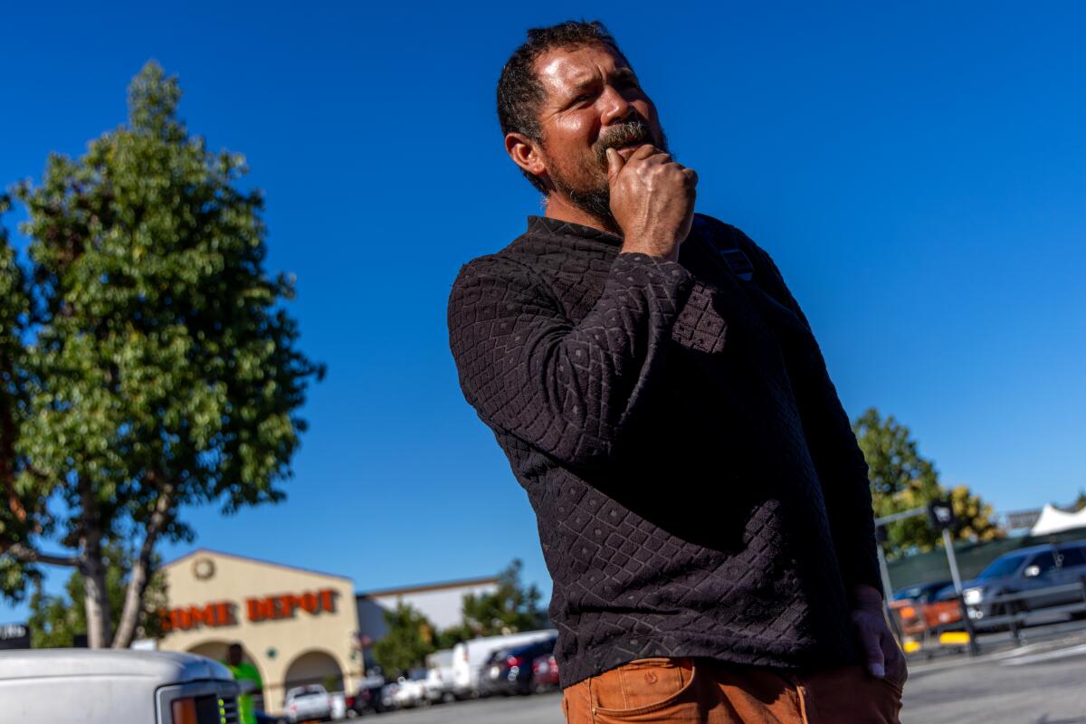 Everth Figueroa stands in a parking lot outside a Home Depot