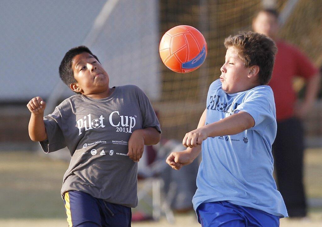 California's Pedro Martinez, left, battle's Sonora's Dennis Escobar for the ball in a boys' 3-4 silver division game Friday.