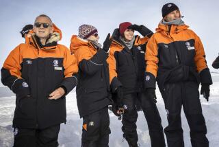 New Zealand Prime Minister Jacinda Ardern, second right, with her partner Clarke Gayford, right, are explained the sites by Antarctica New Zealand chief executive Sarah Williamson shortly after stepping off the plane in Antarctica, Wednesday, Oct. 26, 2022. Delegations from Russia and Ukraine are among those meeting in Australia this week to decide the future of Antarctica's pristine waters. (Mike Scott/NZ Herald/Pool via AP)