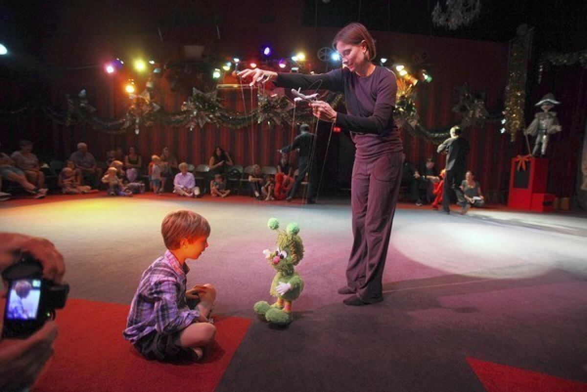 Nathan Palat, 5, gets an up-close look as puppeteer Adrian Rose controls her marionette during a performance of "Halloween Hoop-de-Doo" at the Bob Baker Marionette Theater near downtown Los Angeles.