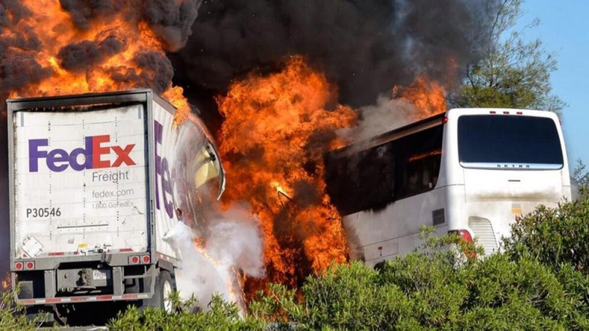 Flames erupt after a fatal 2014 crash near Orland involving a FedEx truck and a bus carrying Los Angeles-area high school students on a visit to a Northern California college.
