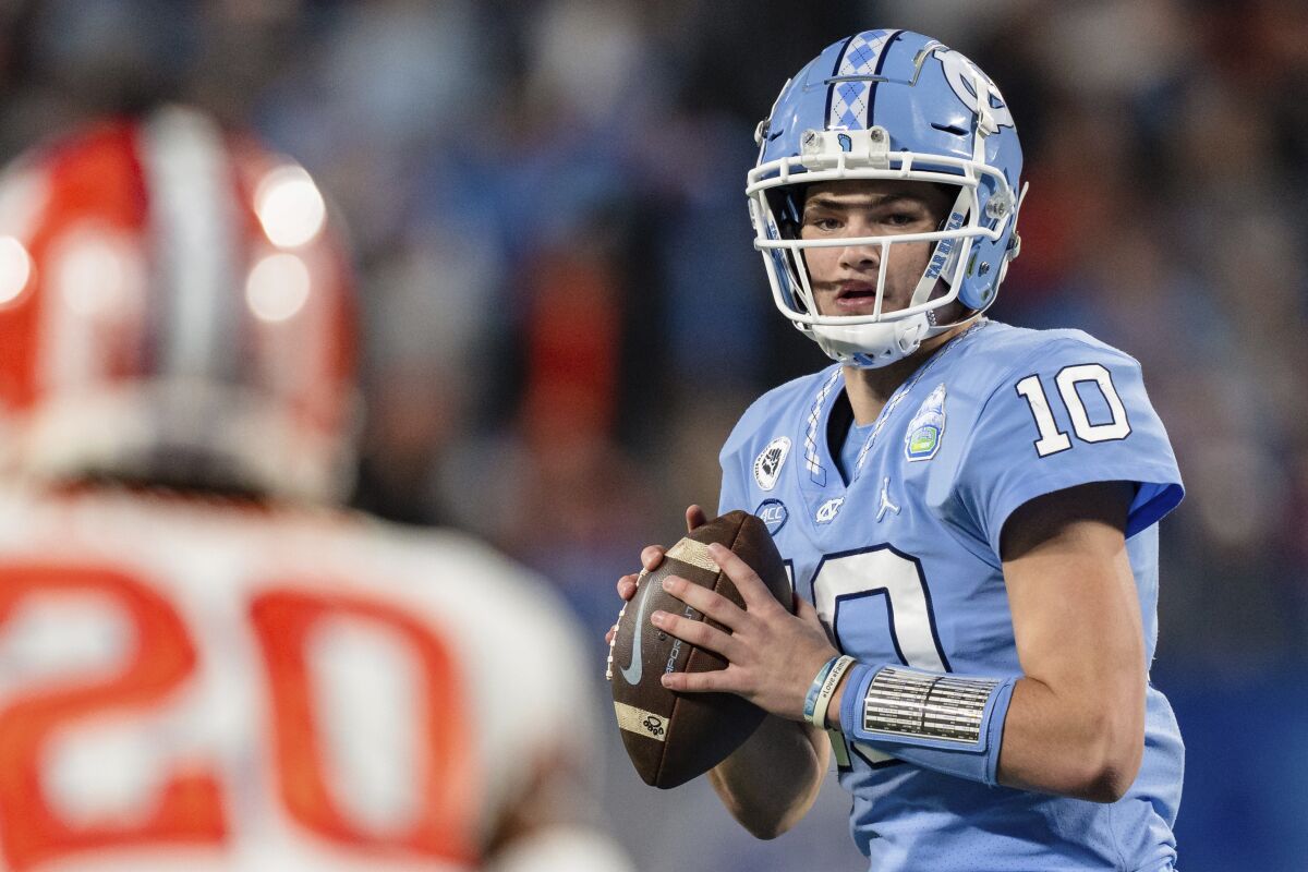 North Carolina quarterback Drake Maye (10) looks to pass in the first half during the Atlantic Coast Conference championship NCAA college football game against Clemson on Saturday, Dec. 3, 2022, in Charlotte, N.C. (AP Photo/Jacob Kupferman)