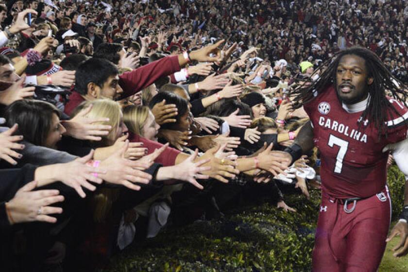 South Carolina defensive end Jadeveon Clowney celebrates with fans after the Gamecocks' win over Clemson on Nov. 30.