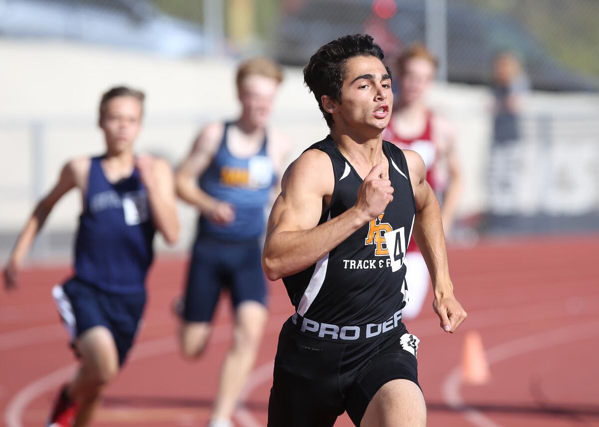 Huntington Beach High's Dylan Plantinga rounds the final turn in the boys' 400-meter event during the Wave League finals at Laguna Beach on Thursday.