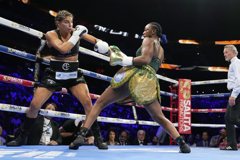 Claressa Shields, right, leans back from Maricela Cornejo during a middleweight boxing bout Saturday, June 3, 2023, in Detroit. (AP Photo/Carlos Osorio)
