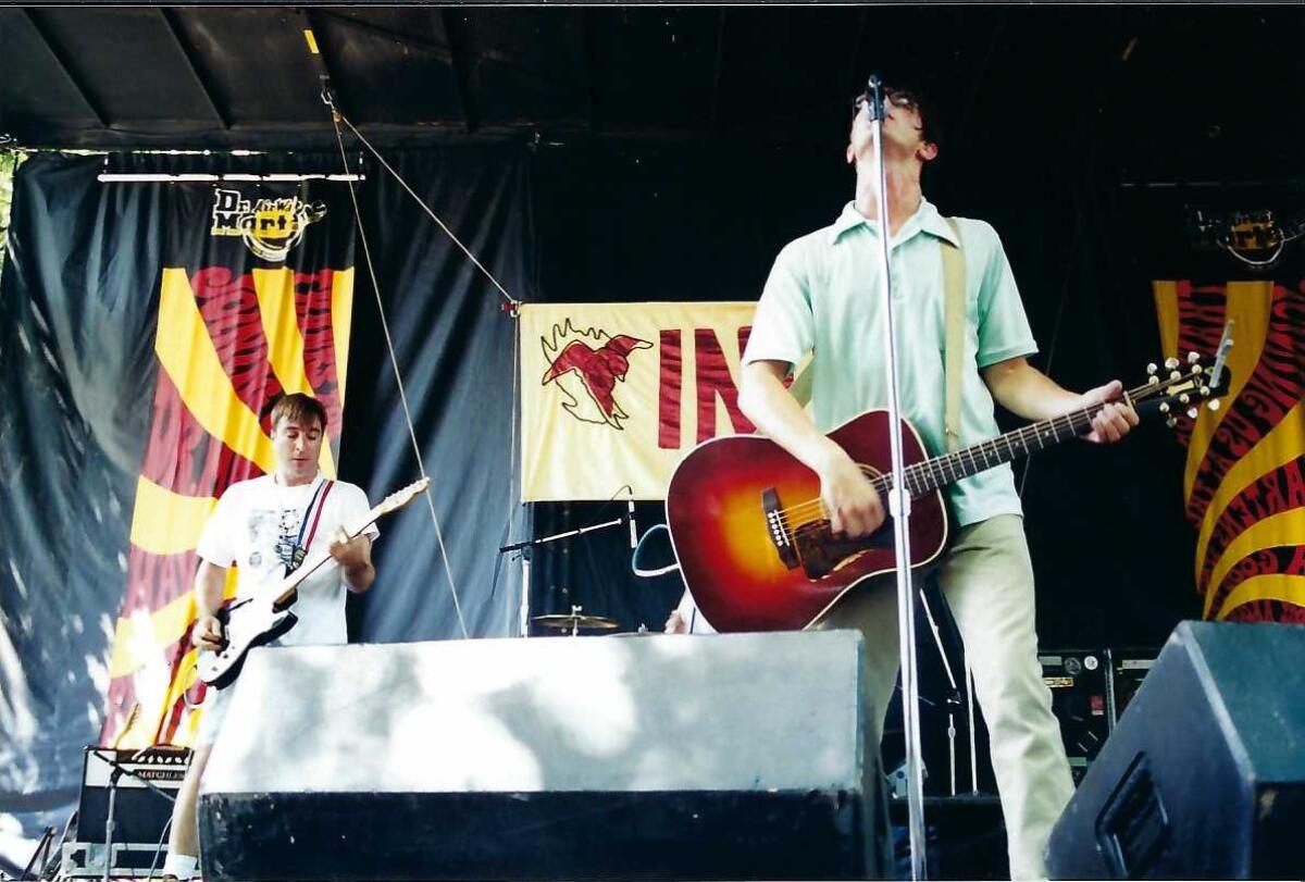 Two musicians onstage playing guitars