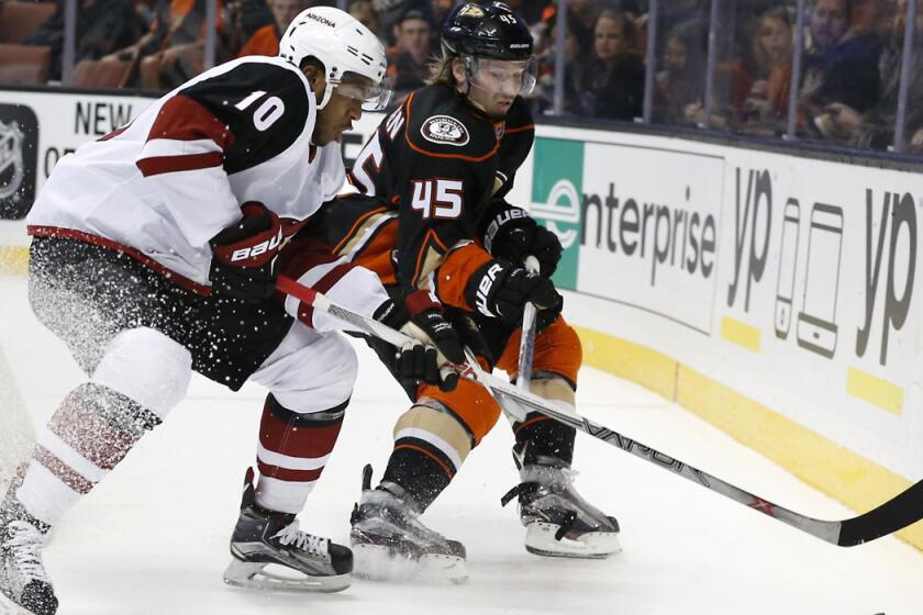 Arizona Coyotes' Anthony Duclair, left, battles Anaheim Ducks defenseman Sami Vatanen in the first period on Friday.