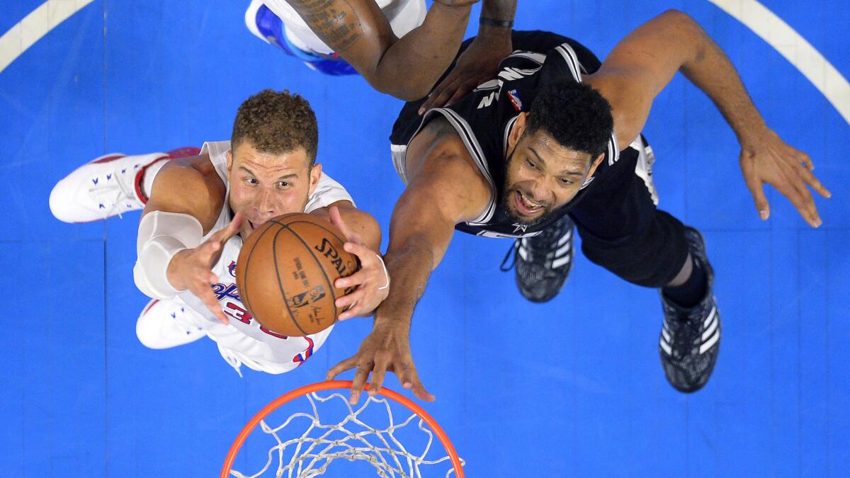 Clippers forward Blake Griffin, left, grabs a rebound in front of San Antonio Spurs forward Tim Duncan during the Clippers' loss in Game 5 of the Western Conference quarterfinals at Staples Center on April 28.
