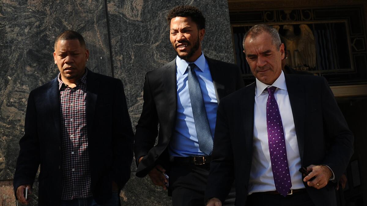 New York Knicks guard Derrick Rose, center, leaves U.S. District Court in downtown Los Angeles after being cleared on allegations of sexual battery in a civil trial.