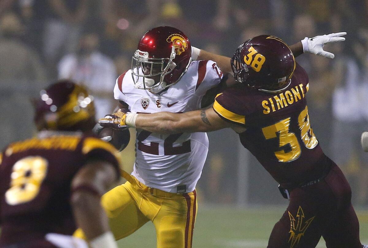 USC's Justin Davis tries to get past Arizona State's Jordan Simone (38) during the first half Saturday in Tempe.