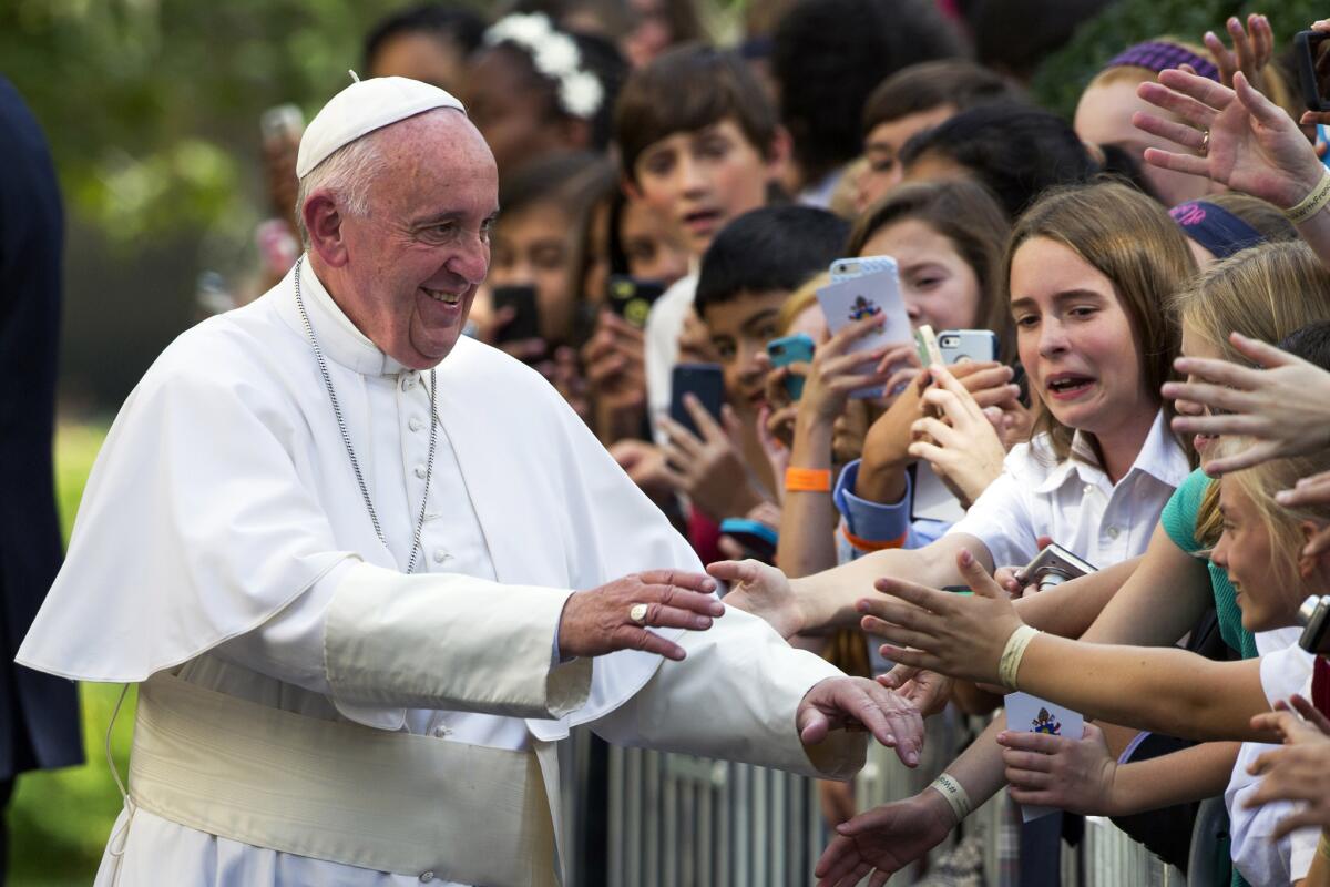 Pope Francis greets school children as he departs the Apostolic Nunciature, the Vatican's diplomatic mission in the heart of Washington, en route Andrews Air Force Base. (AP Photo/Cliff Owen)