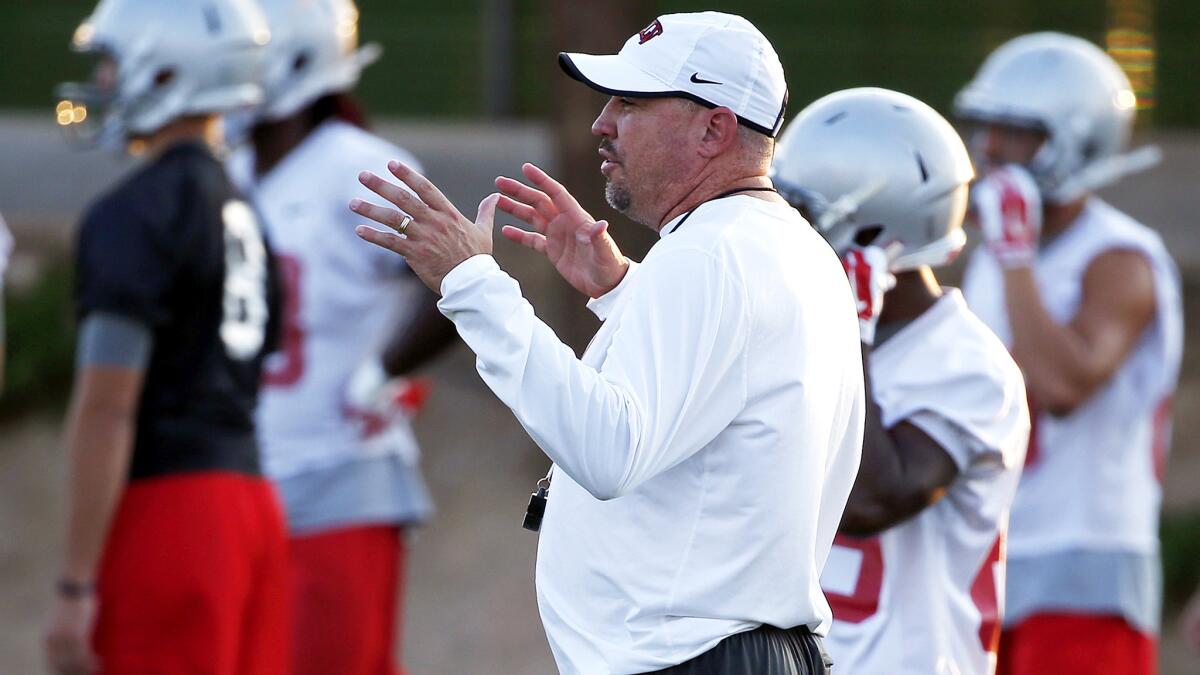 Coach Tony Sanchez makes a point during a UNLV training session on Aug. 20.