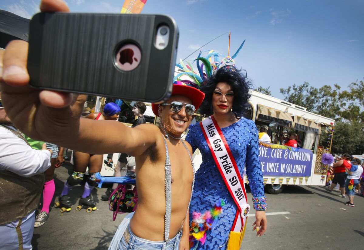 SAN DIEGO, CA: July 15, 2017 | Fonzi Figueroa, left, of Hillcrest, and Cassidy Richards, Miss Gay Pride SD 2017, right, of North Park take a selfie photo before the 2017 San Diego Pride parade began. | Photo by Howard Lipin/San Diego Union-Tribune/ZUMA PRESS