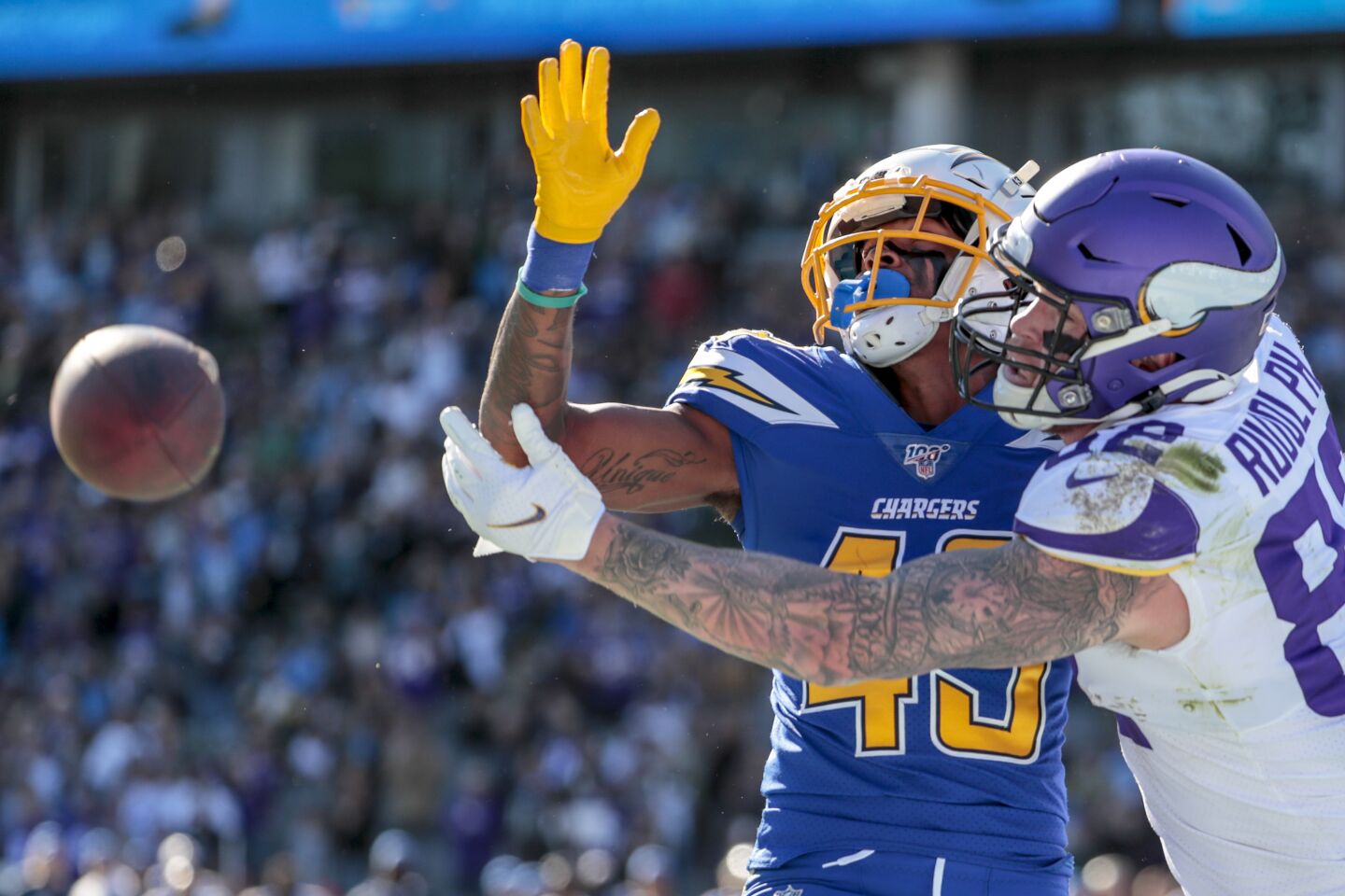 Chargers cornerback Michael Davis, left, draws a pass interference penalty while guarding Minnesota Vikings tight end Kyle Rudolph.
