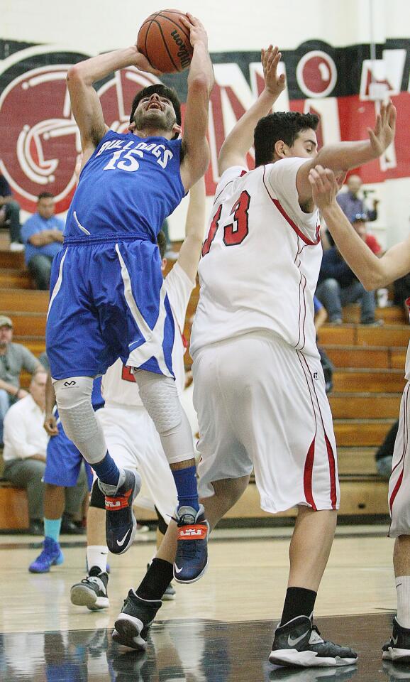 Burbank's Richard Elmoyan goes up for a shot attempt past Glendale's Arthur Terzyan during a game at Glendale High on Tuesday, January 21, 2014.