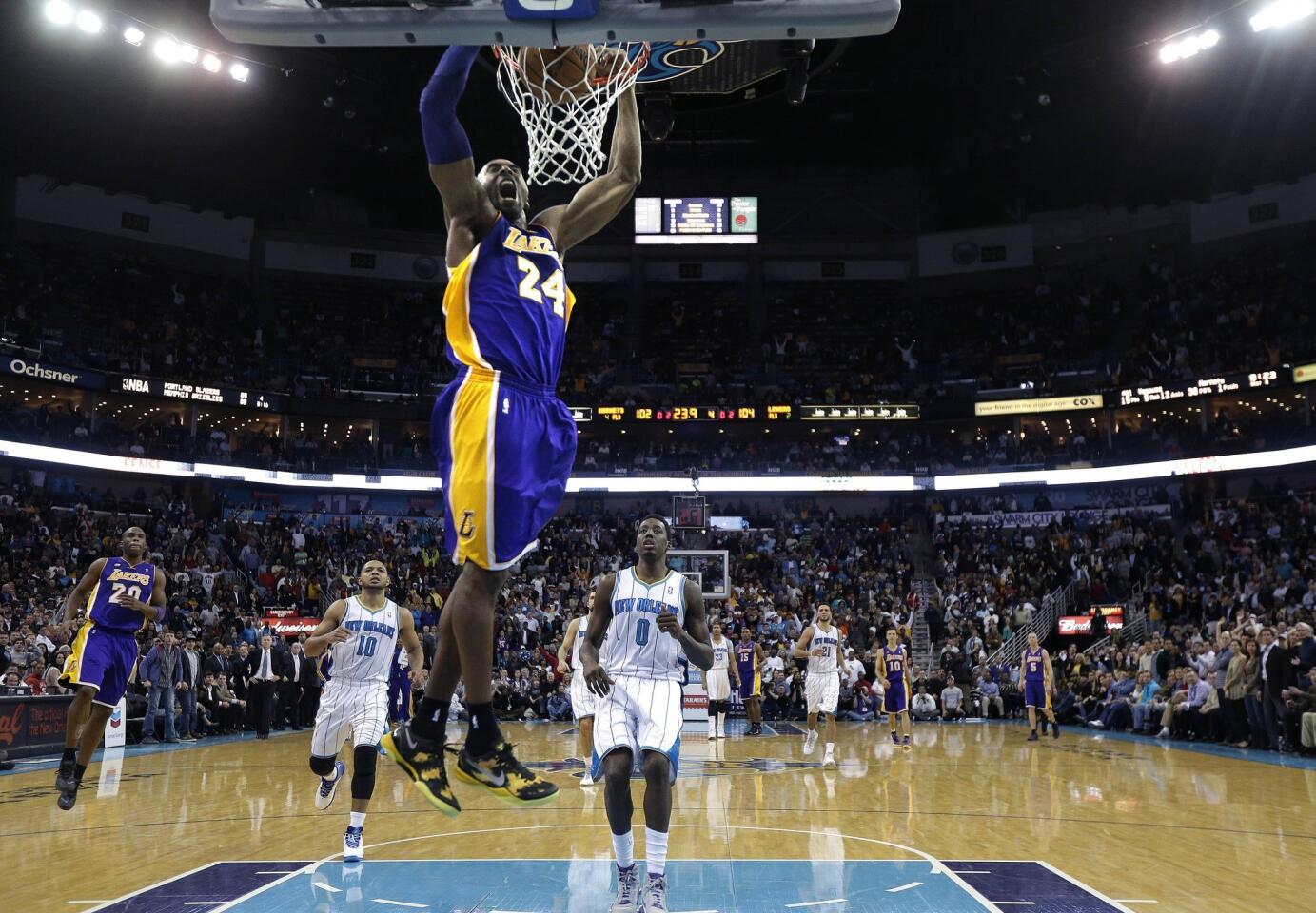 Lakers guard Kobe Bryant breaks away for a dunk in the final minute against the Hornets to help seal a 108-102 victory in New Orleans on Wednesday night.