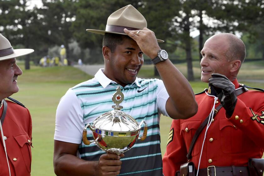 Jhonattan Vegas tries on a mountie's hat during the awards ceremony at the Canadian Open on Sunday.