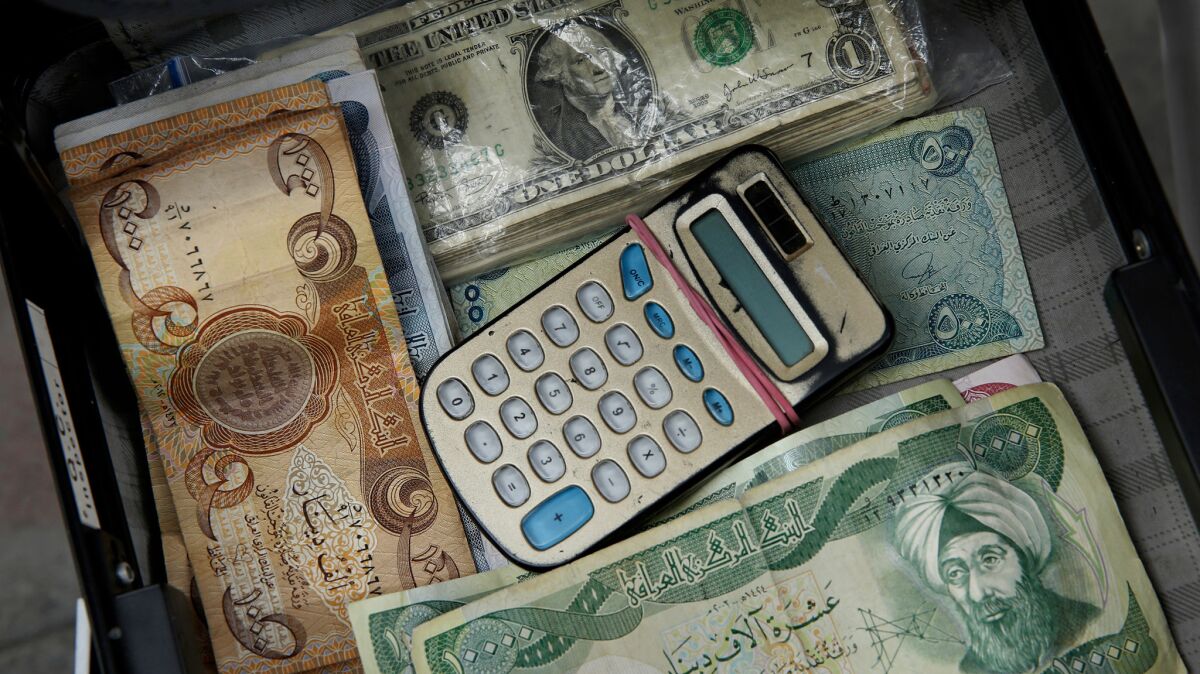 A briefcase is used to store money for currency exchange. Despite the lifting of some U.S. sanctions on Iran, the banking sector is still stifled. Western credit cards are not accepted.