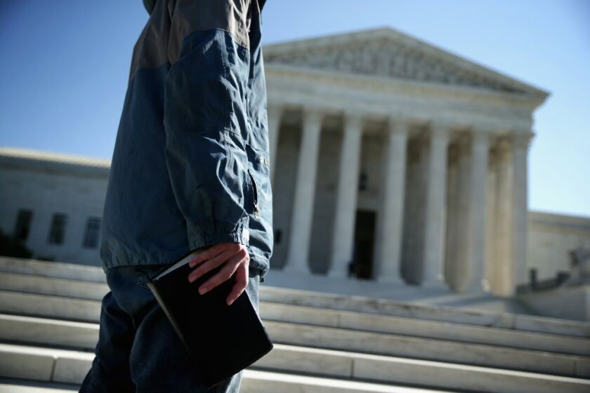 A conservative protester holds a Bible as he participates in a prayer meeting in front of the U.S. Supreme Court building in Washington on Oct. 6.