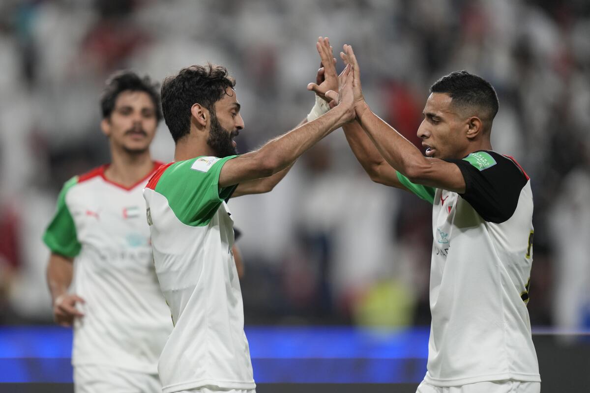Al Jazira's players elebrate after a goal during