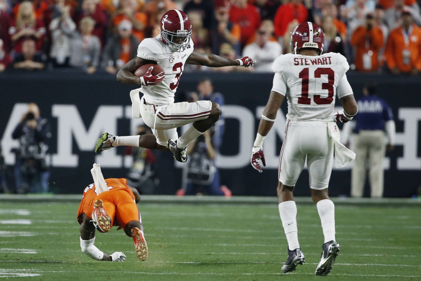 Alabama receiver Calvin Ridley leaps over a Clemson defender in the second quarter.