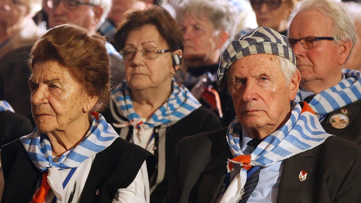 Survivors attend a commemoration event at the former Nazi German concentration and extermination camp Auschwitz II-Birkenau on International Holocaust Remembrance Day in Oswiecim, Poland, on Saturday.