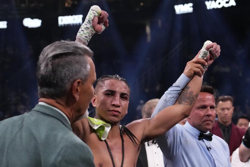 Mario Barrios celebrates defeating Yordenis Ugas after their welterweight boxing match Saturday, Sept. 30, 2023, in Las Vegas. (AP Photo/John Locher)