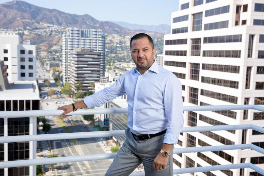 David Gasparyan stands outside his office in Glendale, CA