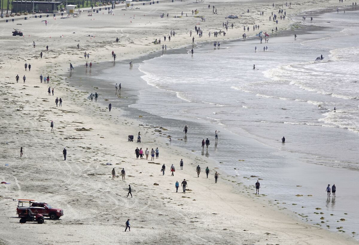 Gov. Gavin Newsom announced that San Diego County beaches would be allowed to remain open. Here people walk along La Jolla Shores on April 30, 2020.