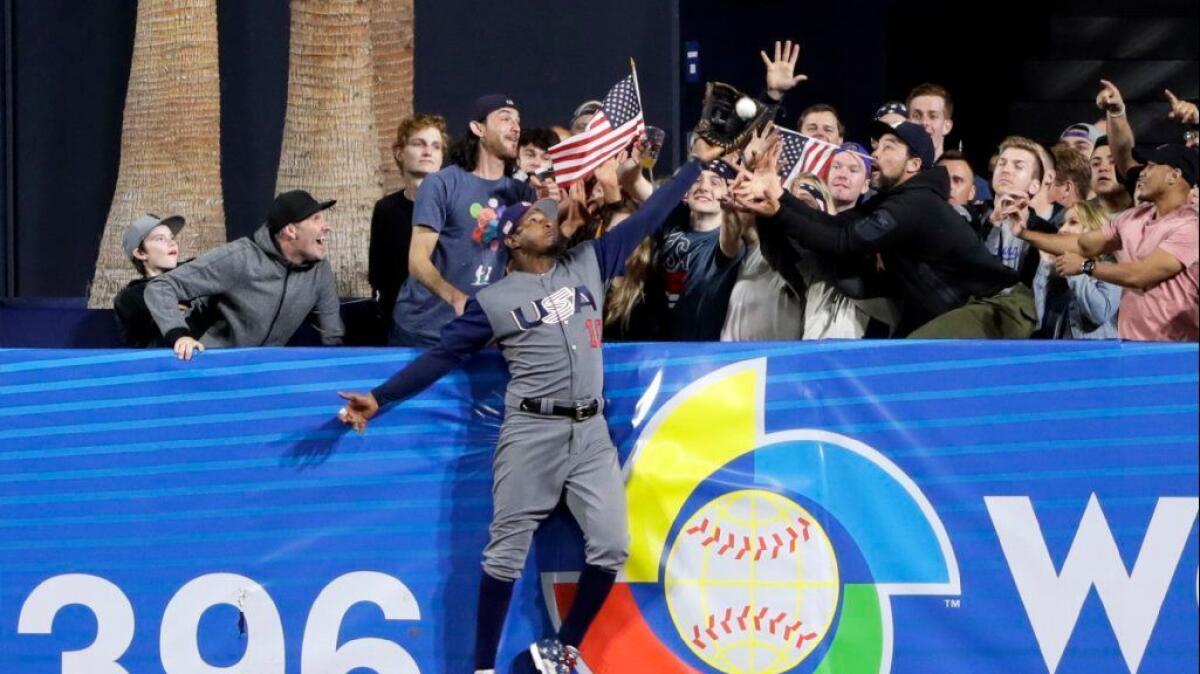 U.S. outfielder Adam Jones makes a catch above the wall, stealing a home run from the Dominican Republic's Manny Machado during the seventh inning of a World Baseball Classic game on March 18.