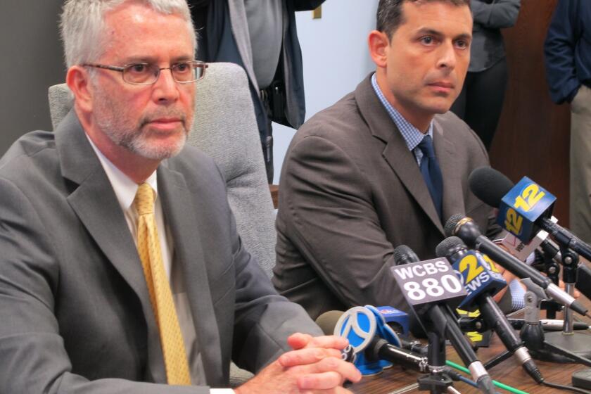 Tom Cutinella, a high school football player, died Wednesday in New York. Shoreham-Wading River Superintendent of Schools Steven Cohen, left, and high school Principal Dan Holtzman speak at a news conference Thursday.