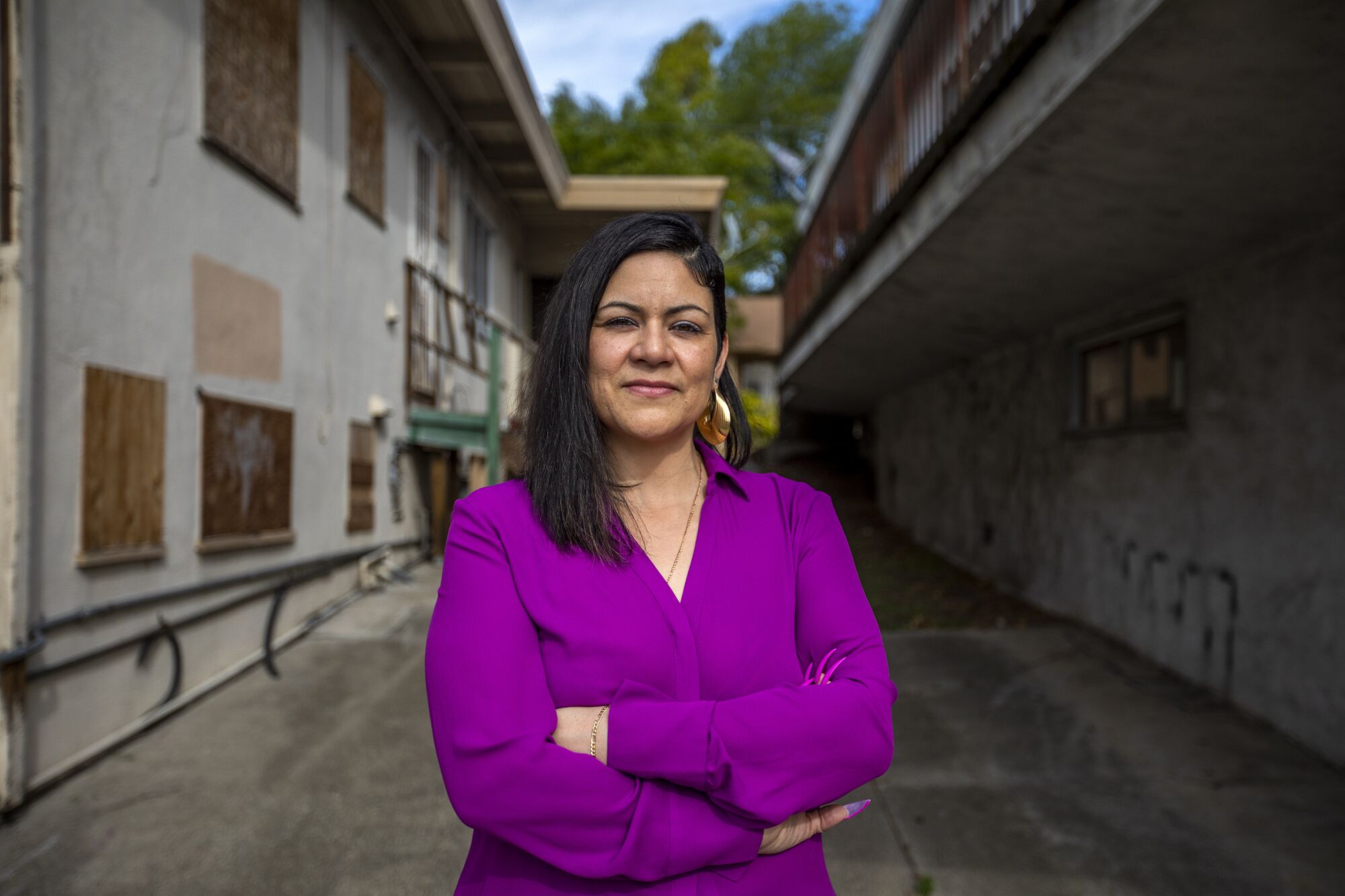 Ida Alvarez stands near her former apartment in Hayward. 