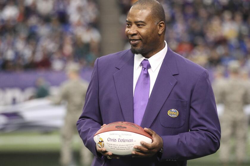 FILE - In this Dec. 15, 2013, file photo, former Minnesota Viking Chris Doleman acknowledges the crowd during a ceremony honoring the All Mall of America Field team during halftime of an NFL football game between the Vikings and the Philadelphia Eagles in Minneapolis. Hall of Fame defensive end Doleman, who became one of the NFL's most feared pass rushers during 15 seasons in the league, has died. He was 58. The Vikings and Pro Football Hall of Fame president and CEO David Baker offered their condolences in separate statements late Tuesday night, Jan. 29, 2020. (AP Photo/Andy King, File)