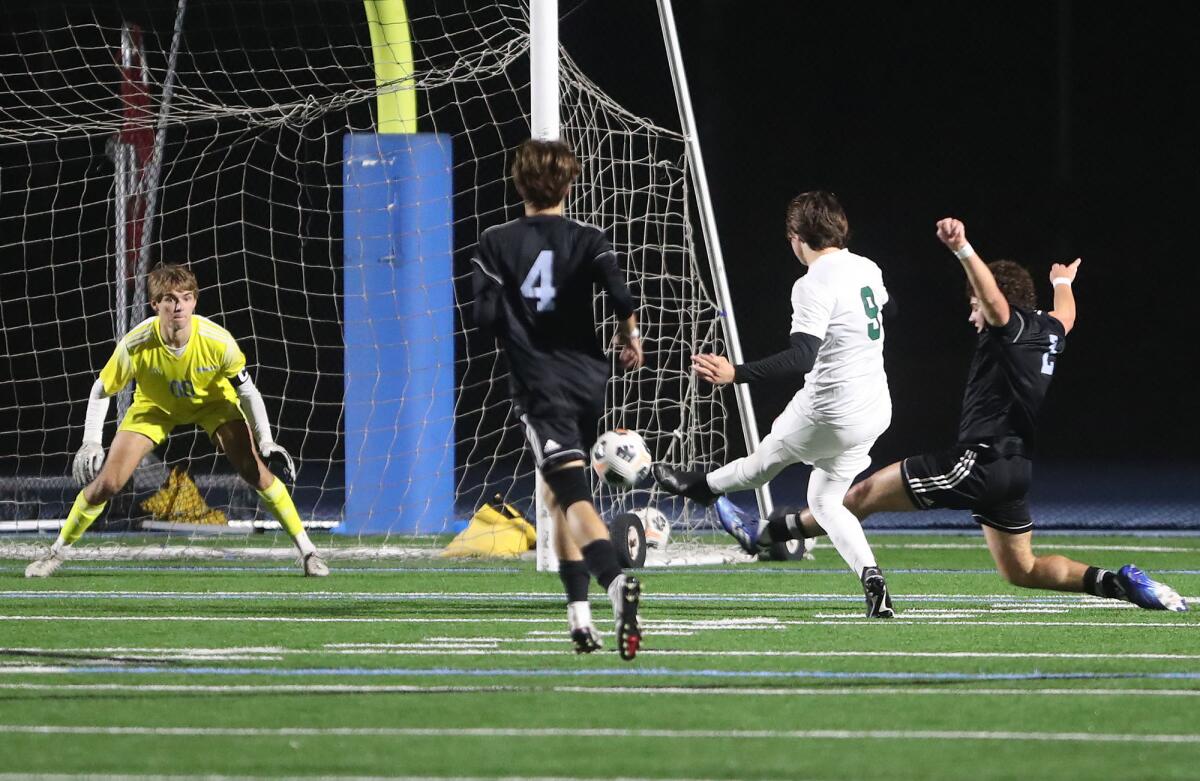 Sage Hill's Jack Weisberg takes a shot and scores under pressure from CdM's Callum Cianfrani late in the first half.