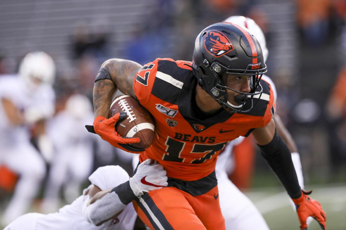 Oregon State wide receiver Isaiah Hodgins slips a tackle from Stanford linebacker Curtis Robinson on Sept. 28 in Corvallis, Ore.