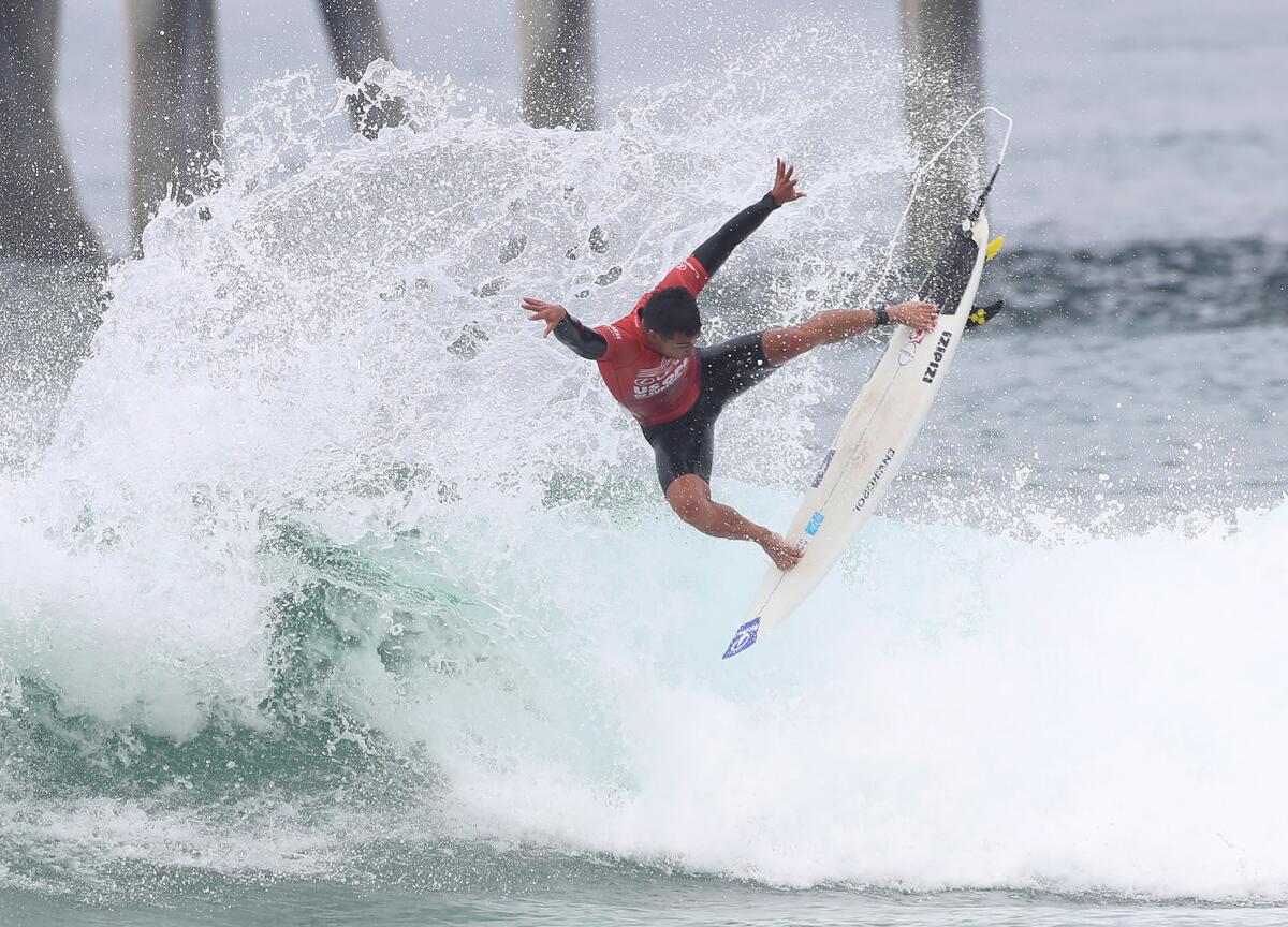 Mihimana Braye flies off the foam as he completes a ride during the U.S. Open of Surfing on Wednesday.