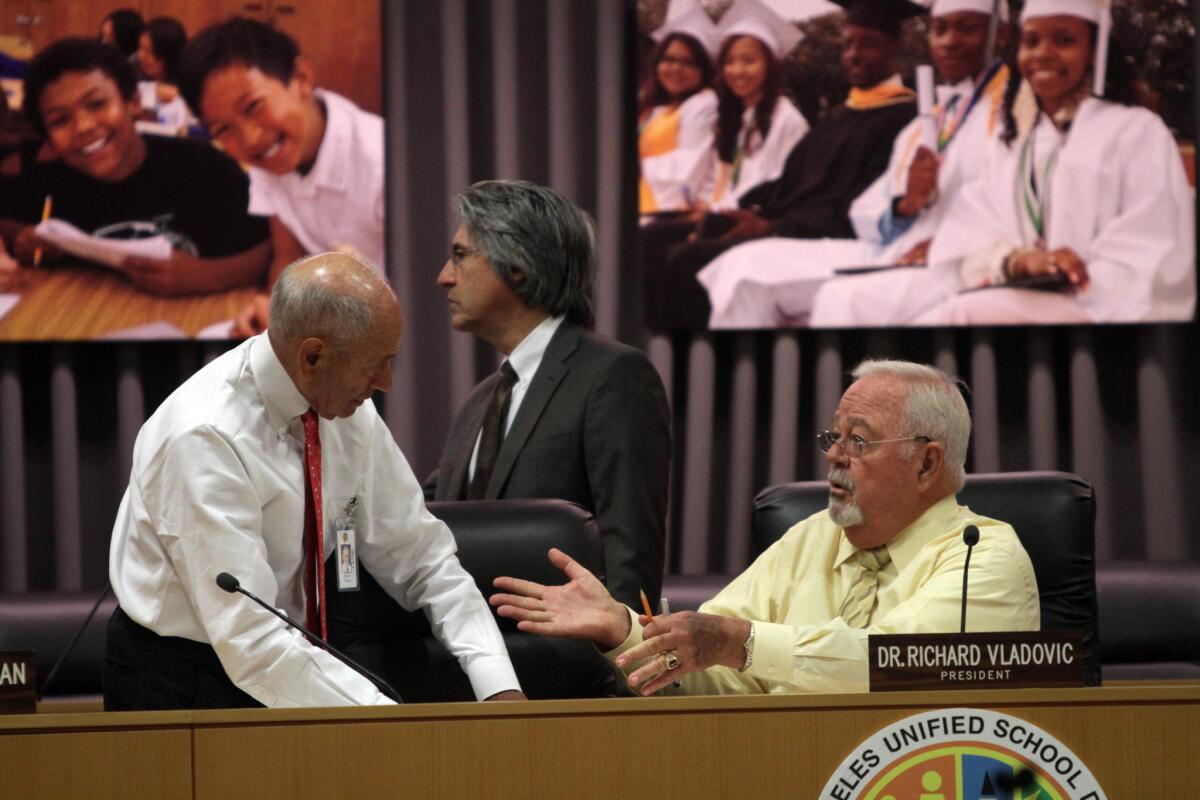 Los Angeles Unified School District Supt. Ramon Cortines, left, talks with school board President Richard Vladovic before an LAUSD board meeting in October.