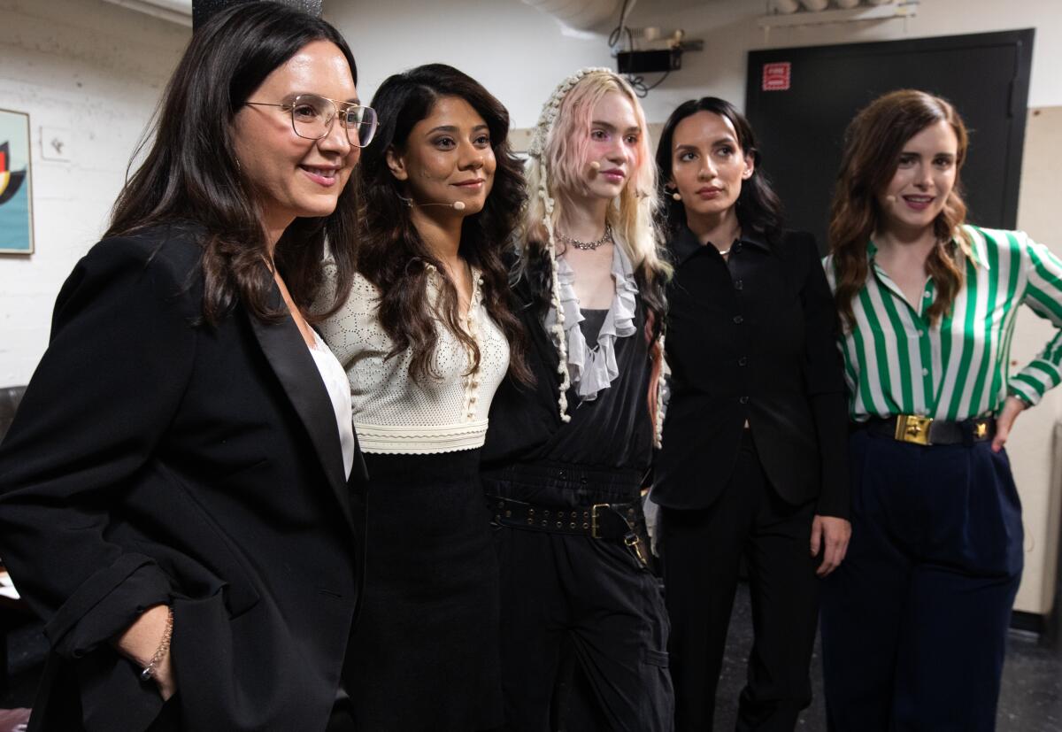 Five women posing for a photograph.