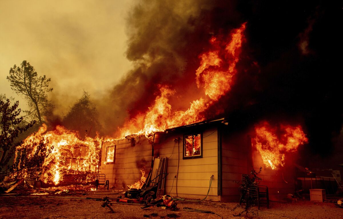 Flames consume a house near Old Oregon Trail in Shasta County, Calif.