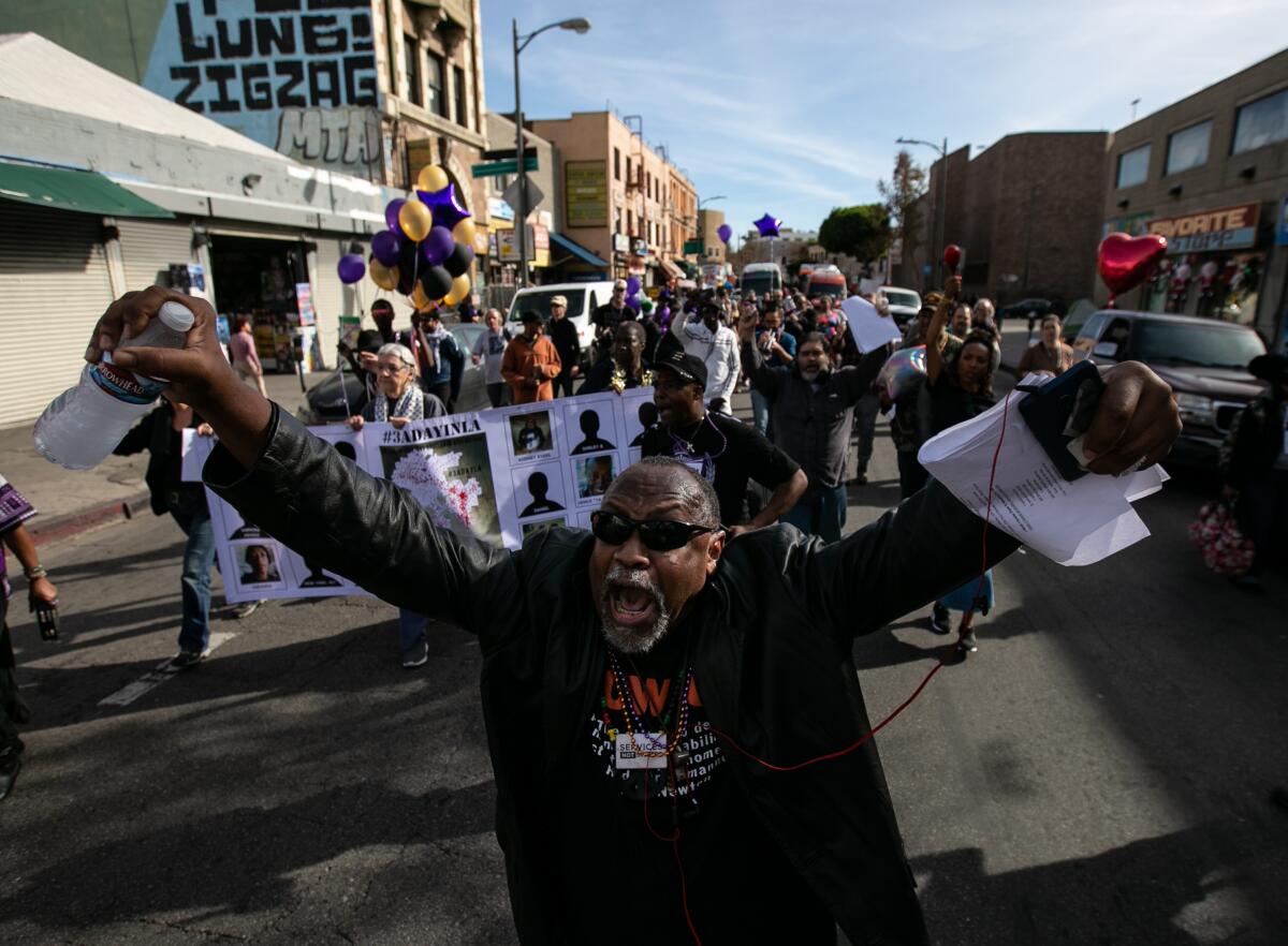 Pancake, a community organizer, leads supporters as they march in downtown Los Angeles in tribute to homeless who died this year.